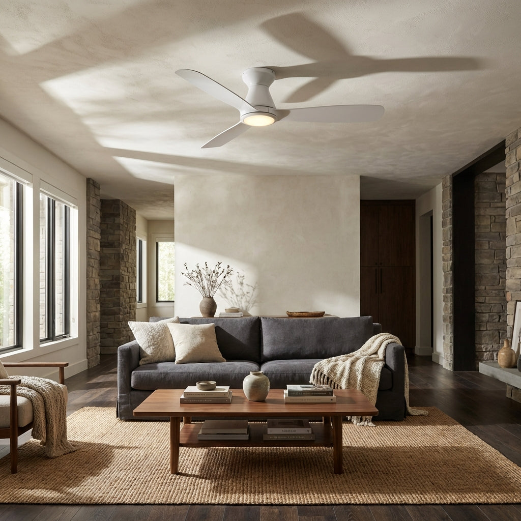 White flush-mount ceiling fan with integrated LED light in a living room.