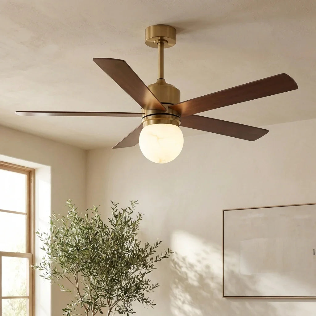 LED ceiling fan with walnut blades, golden downrod, and frosted round light