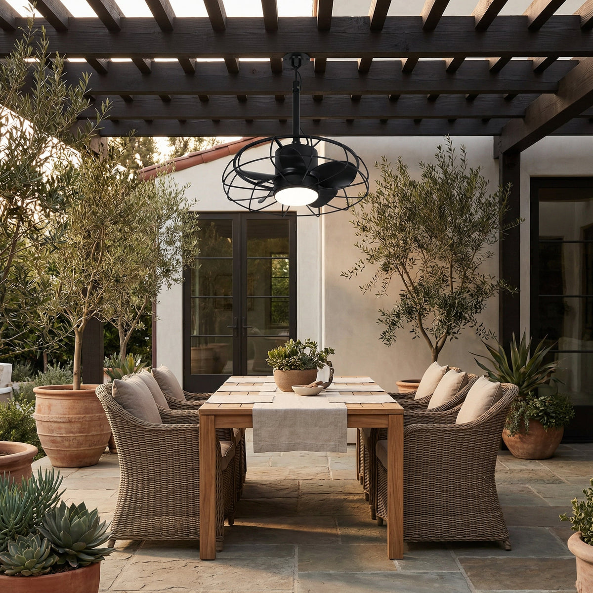 Outdoor black industrial ceiling fan with wire guard and integrated light, installed outdoors