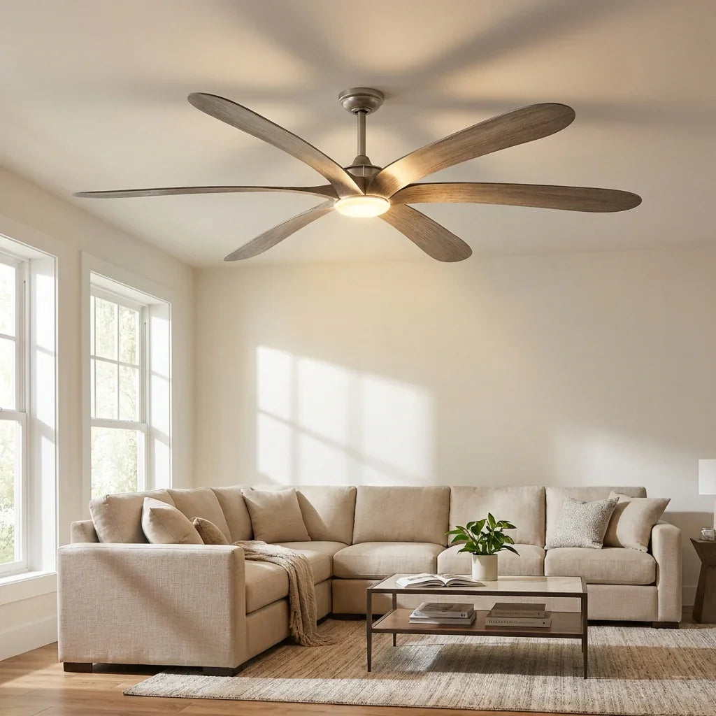 Ceiling fan with five light wood blades and warm-lit frosted light in a living room