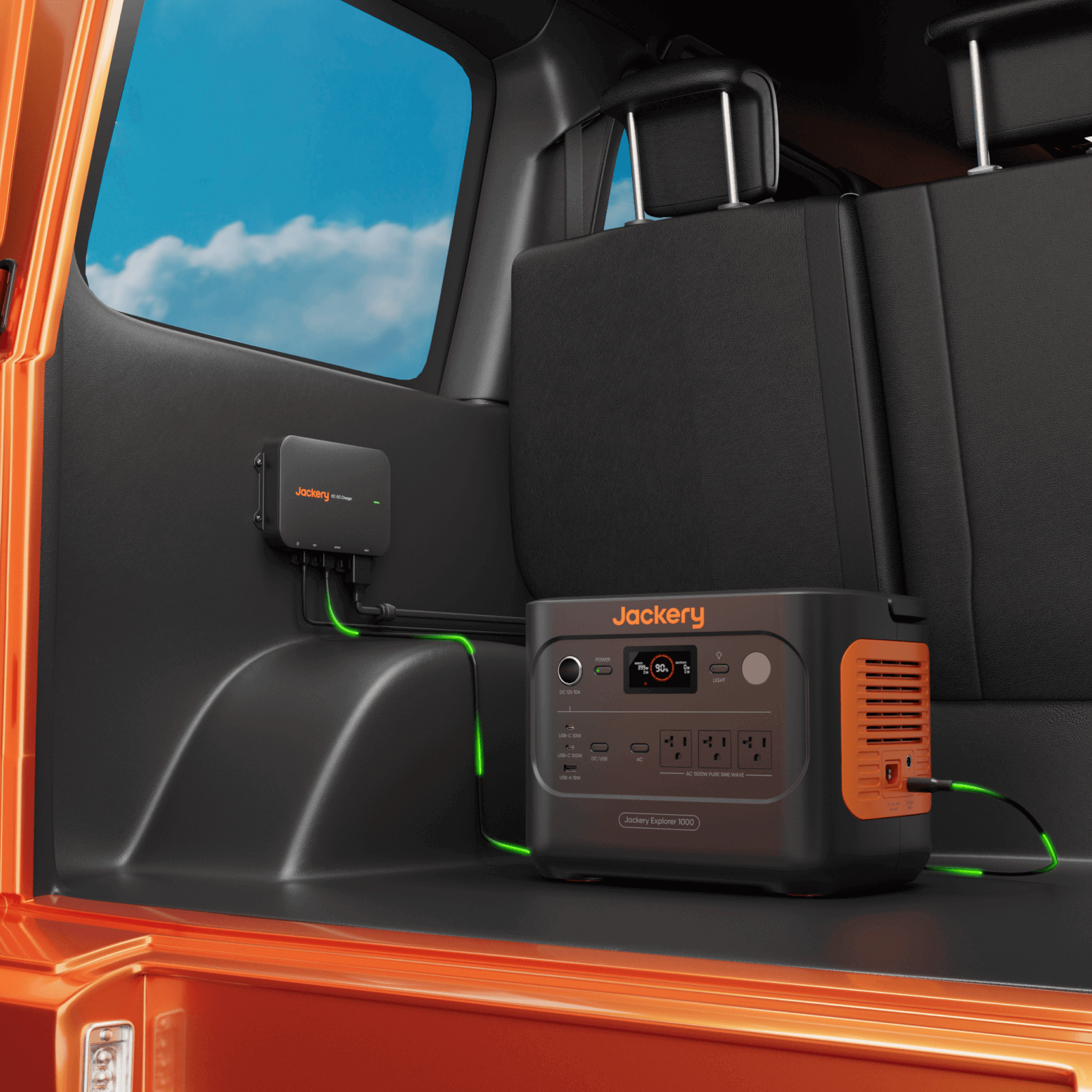 Jackery DC-DC alternator charger installed in car seat area with green LEDs