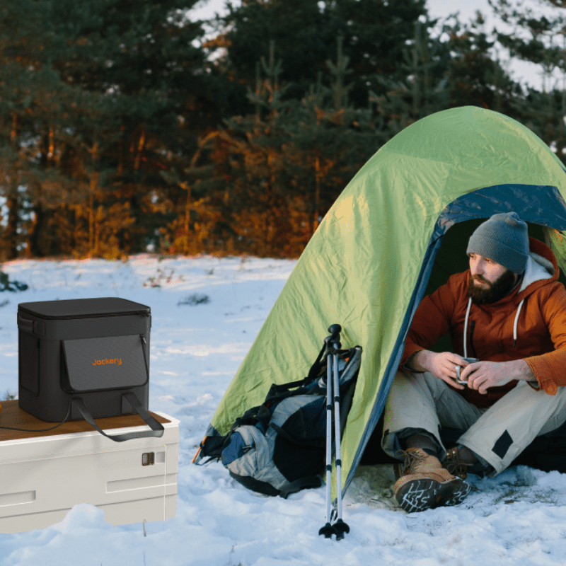 Dark gray carrying bag on snow with zipper top, shown outdoors