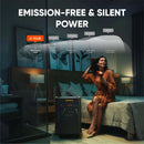 Jackery portable power station positioned beside a bed with quiet operation indicator