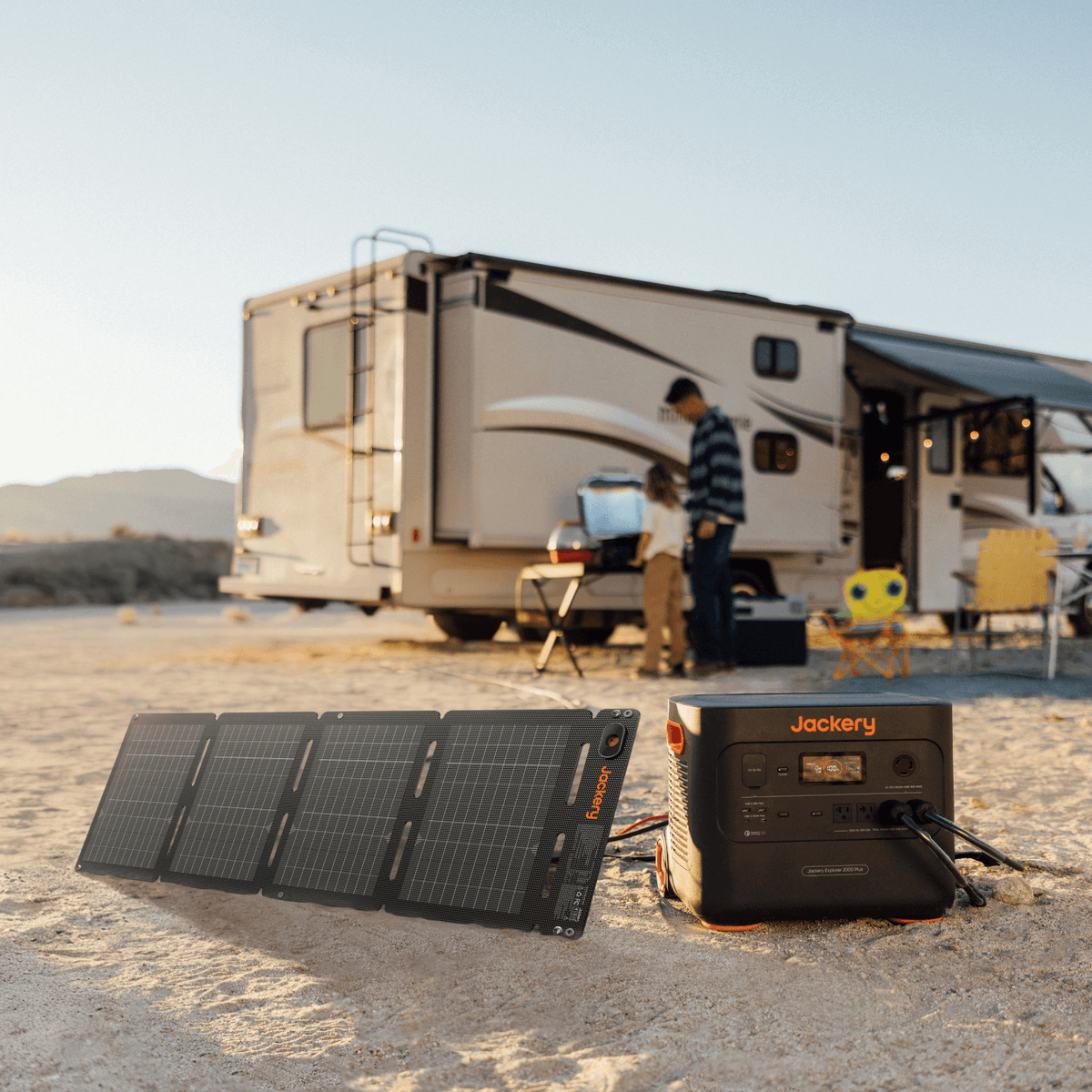 Foldable solar panel lying on sand with four sections and mounting eyelets visible