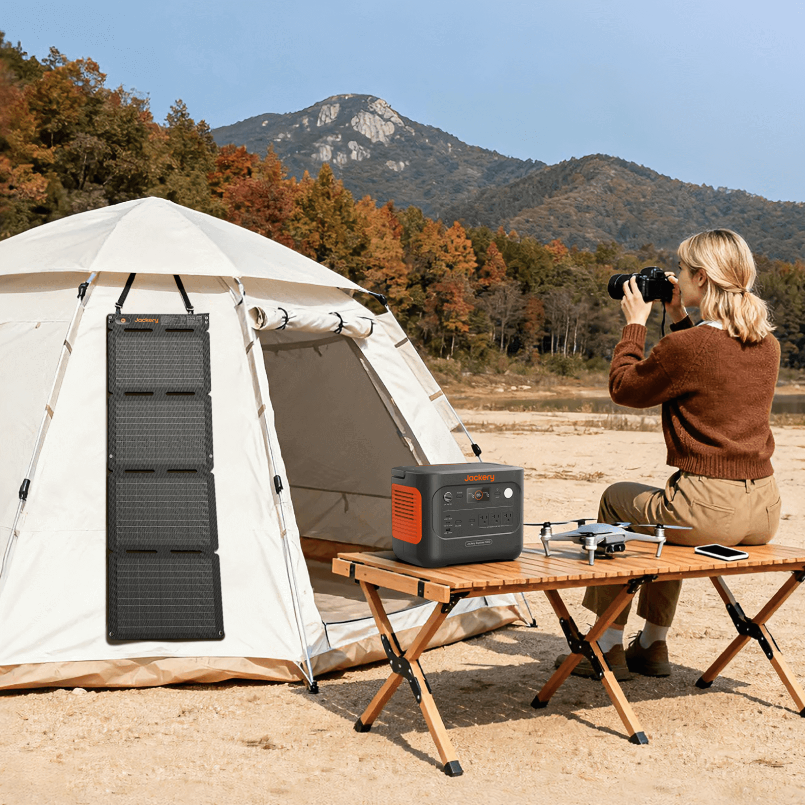 Foldable solar panel with four sections mounted to a tent setup, grid cells visible