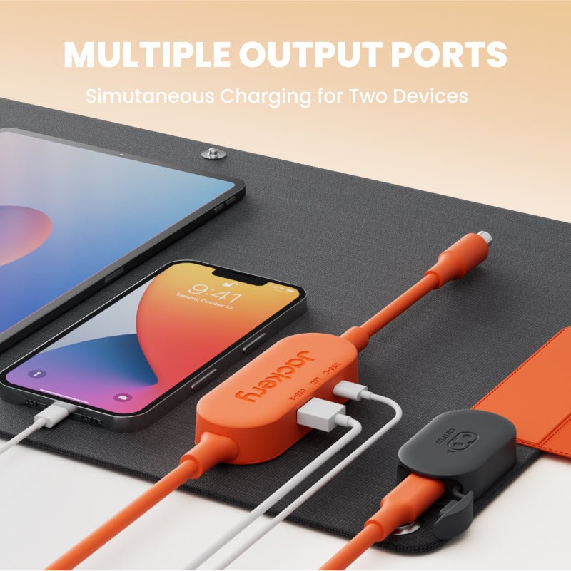 Portable solar panel with orange cable connectors and multiple charging ports