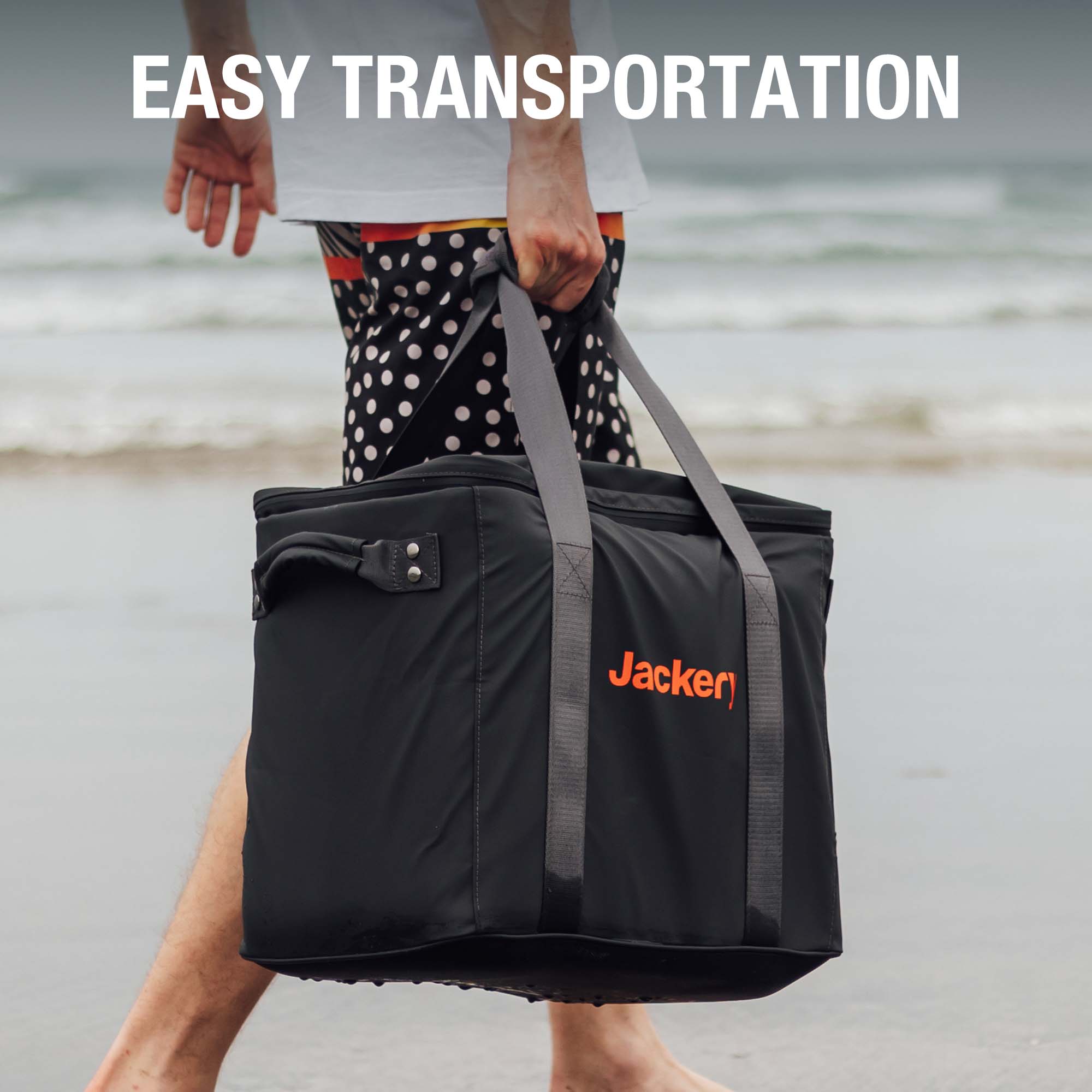 Black tote-style Jackery carrying case with long shoulder strap and orange logo
