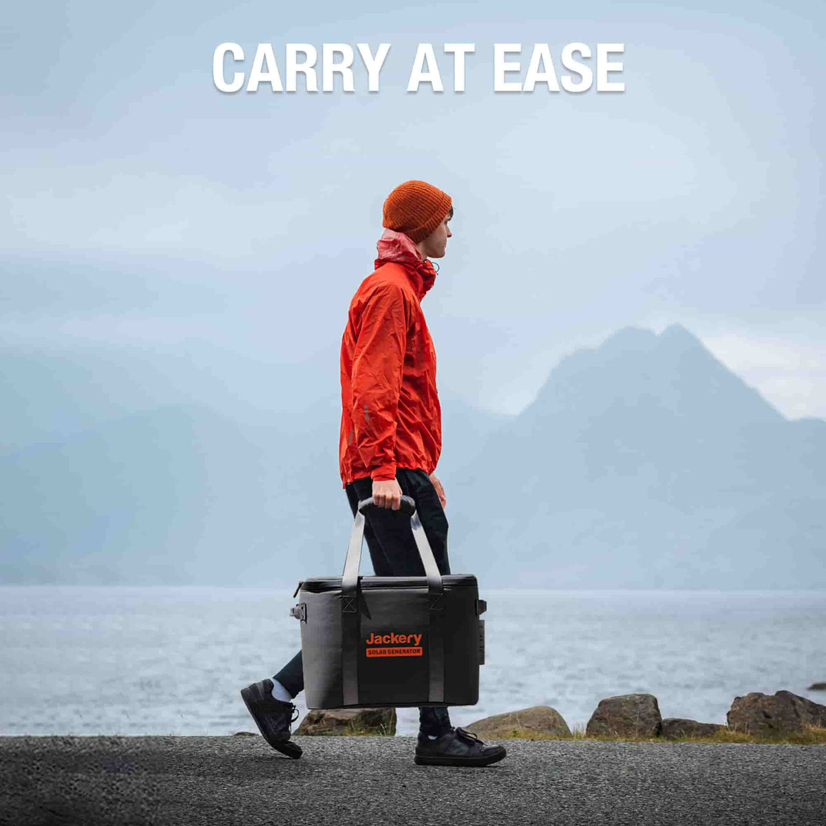 Black Jackery carrying case with handles standing outdoors on a pavement.