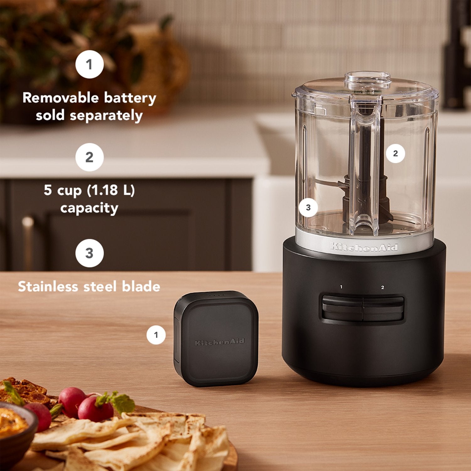 Black matte cordless citrus juicer base with clear container and separate battery pack