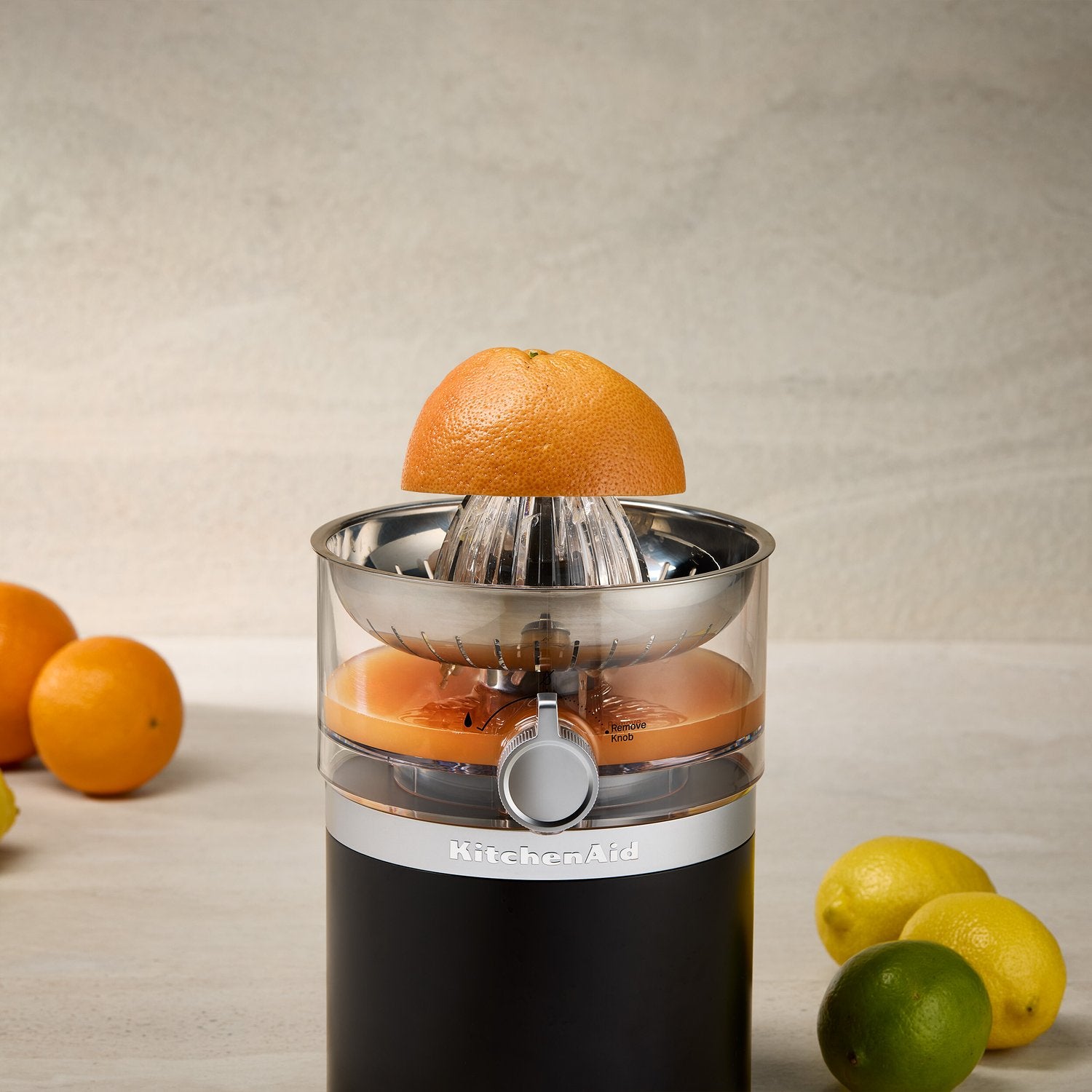 Black matte citrus juicer with orange on the stainless cone