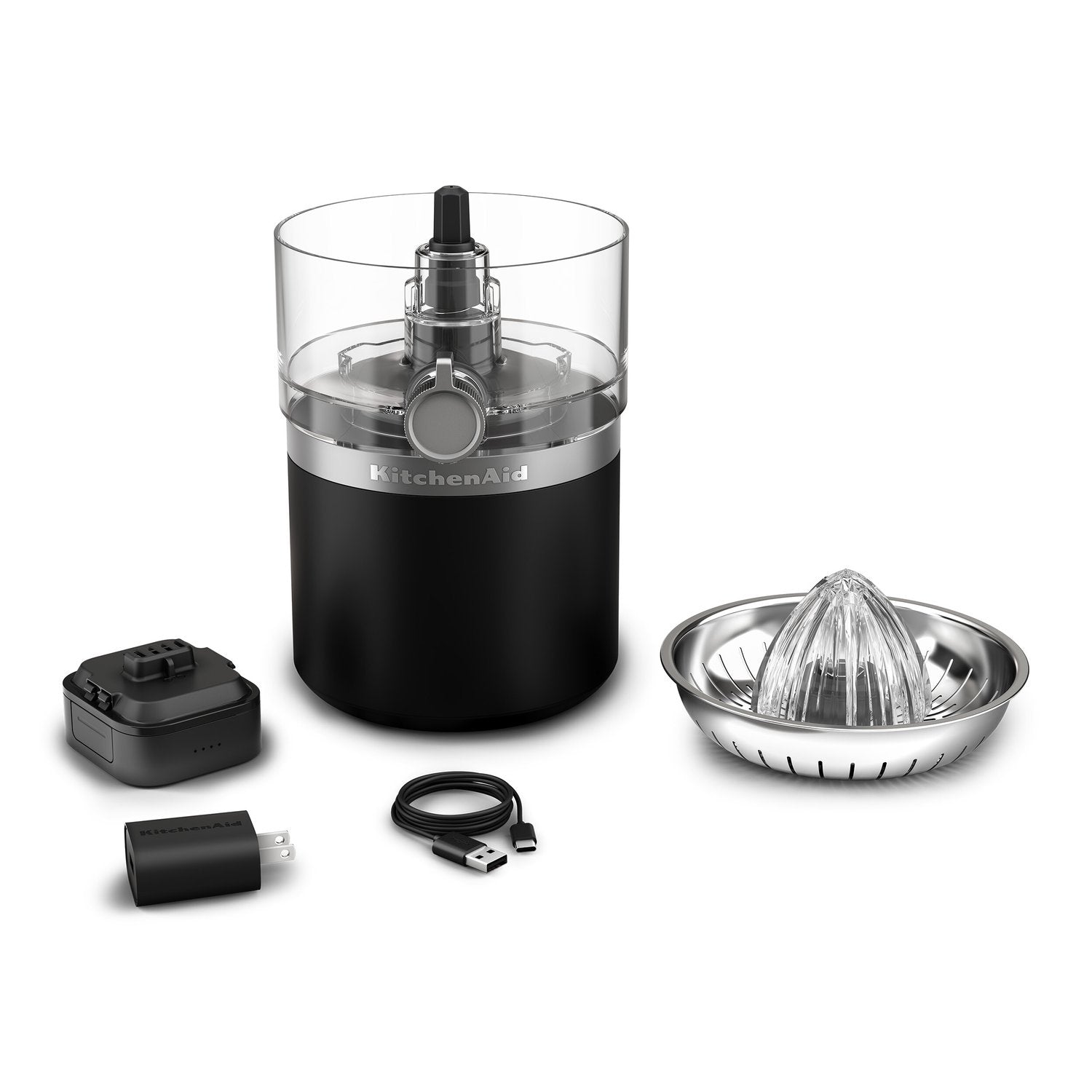 Black matte cordless citrus juicer with clear cup, battery pack, and wall adapter