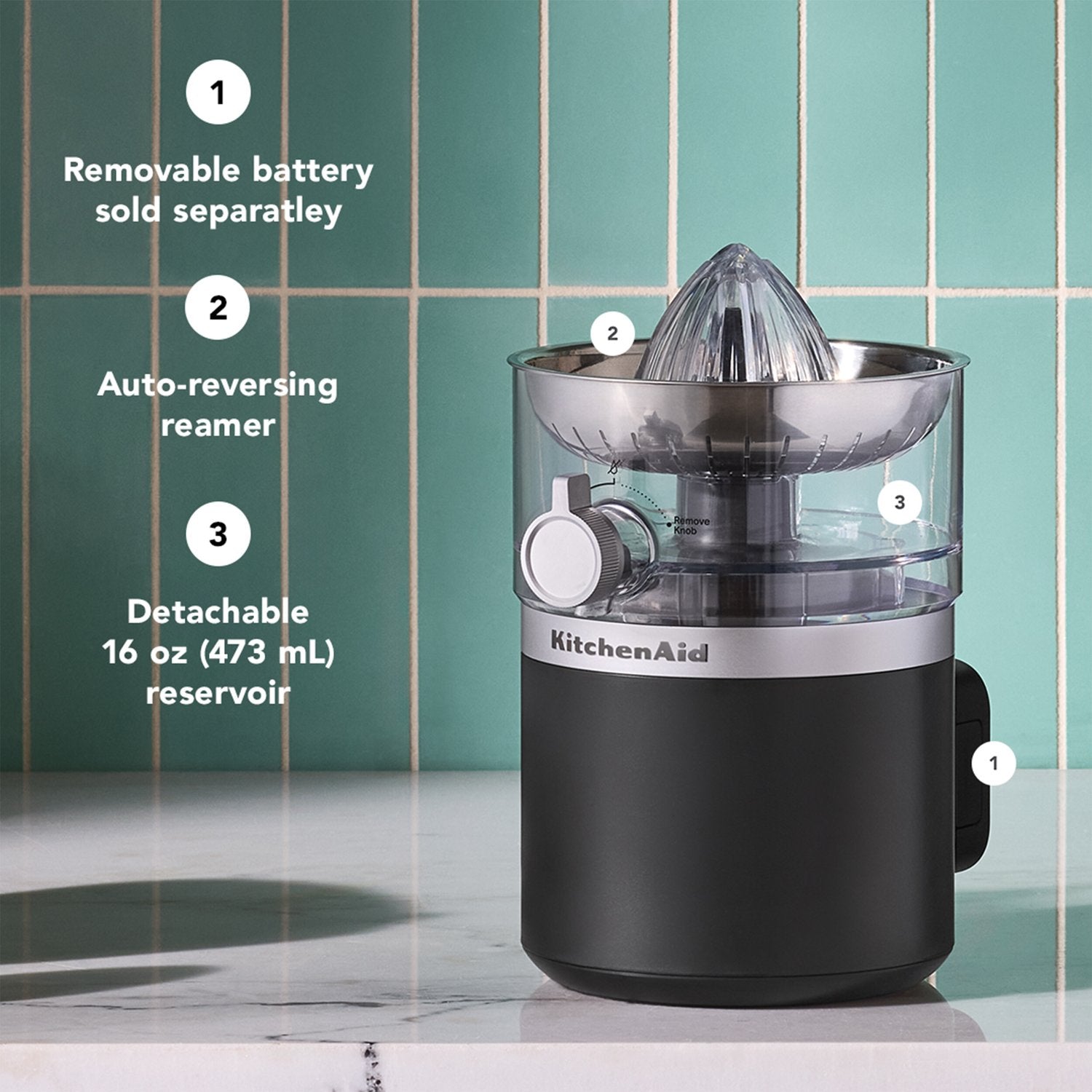 Black cordless citrus juicer with clear reservoir, detachable battery, and reamer
