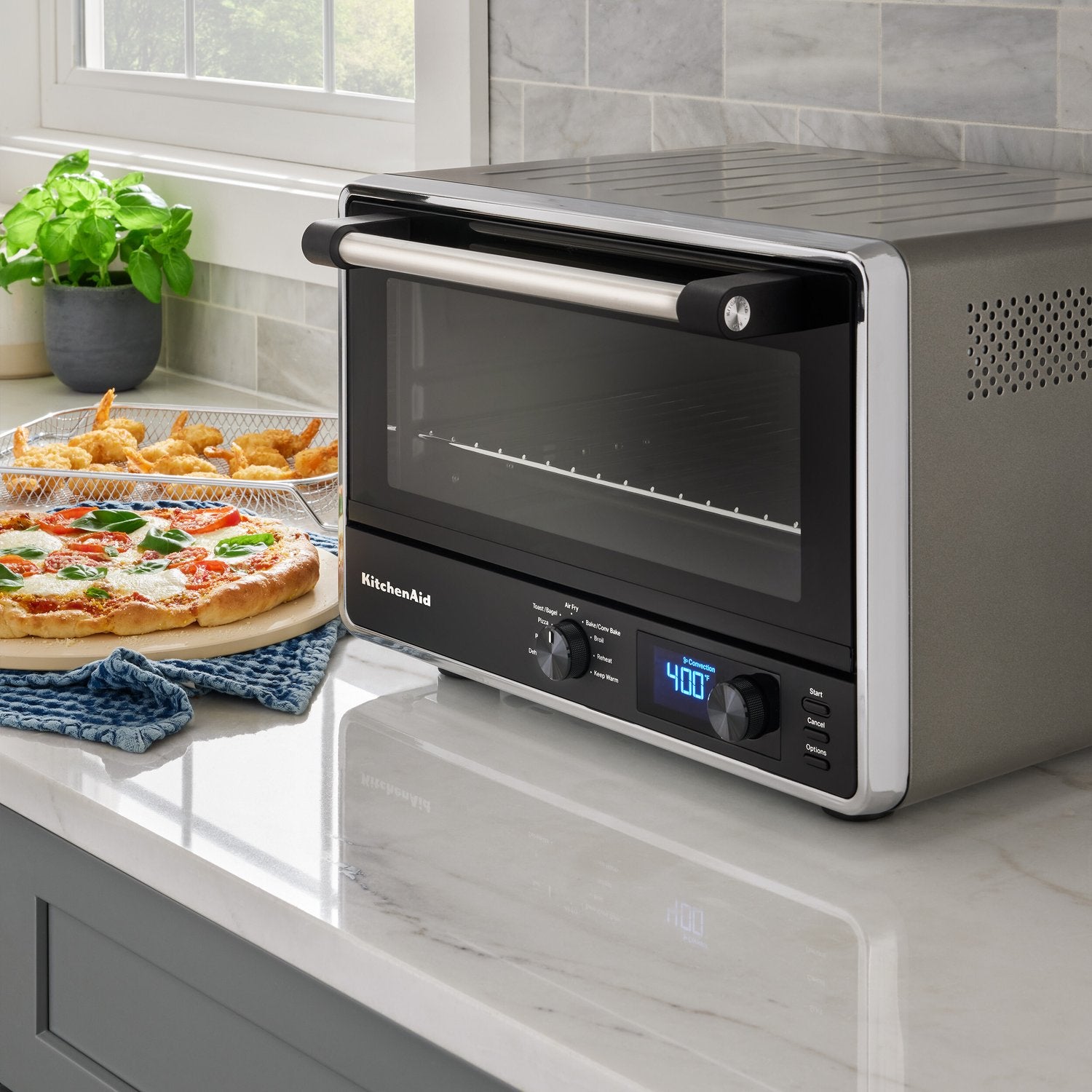 KitchenAid countertop oven on counter with glass door, digital timer display, Contour Silver