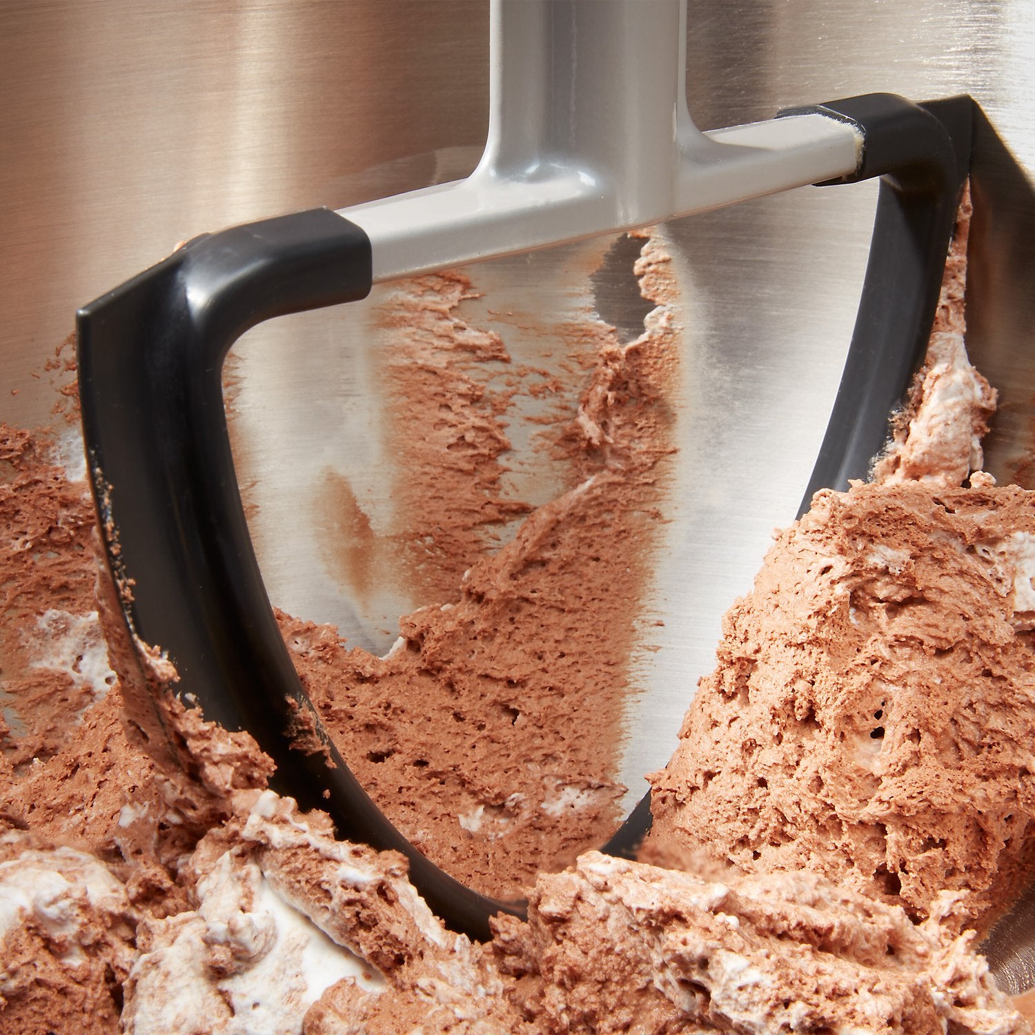 Double flex edge beater scraping batter along the bowl edge with flexible paddle