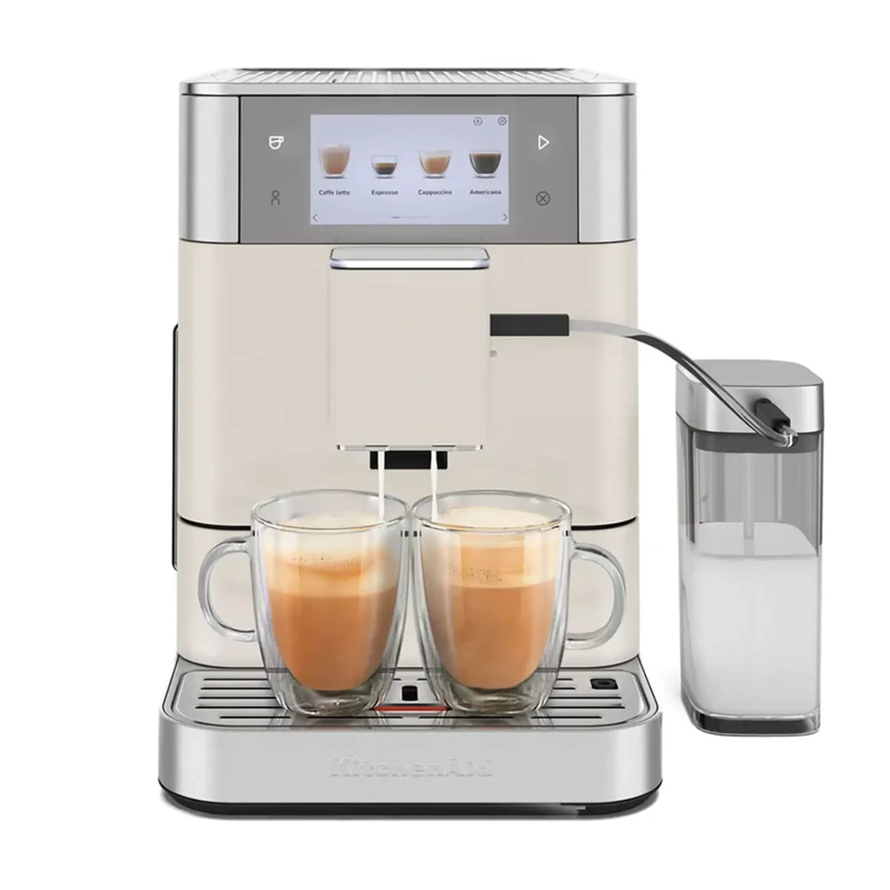 Porcelain white espresso machine filling cups with milk, plus milk container