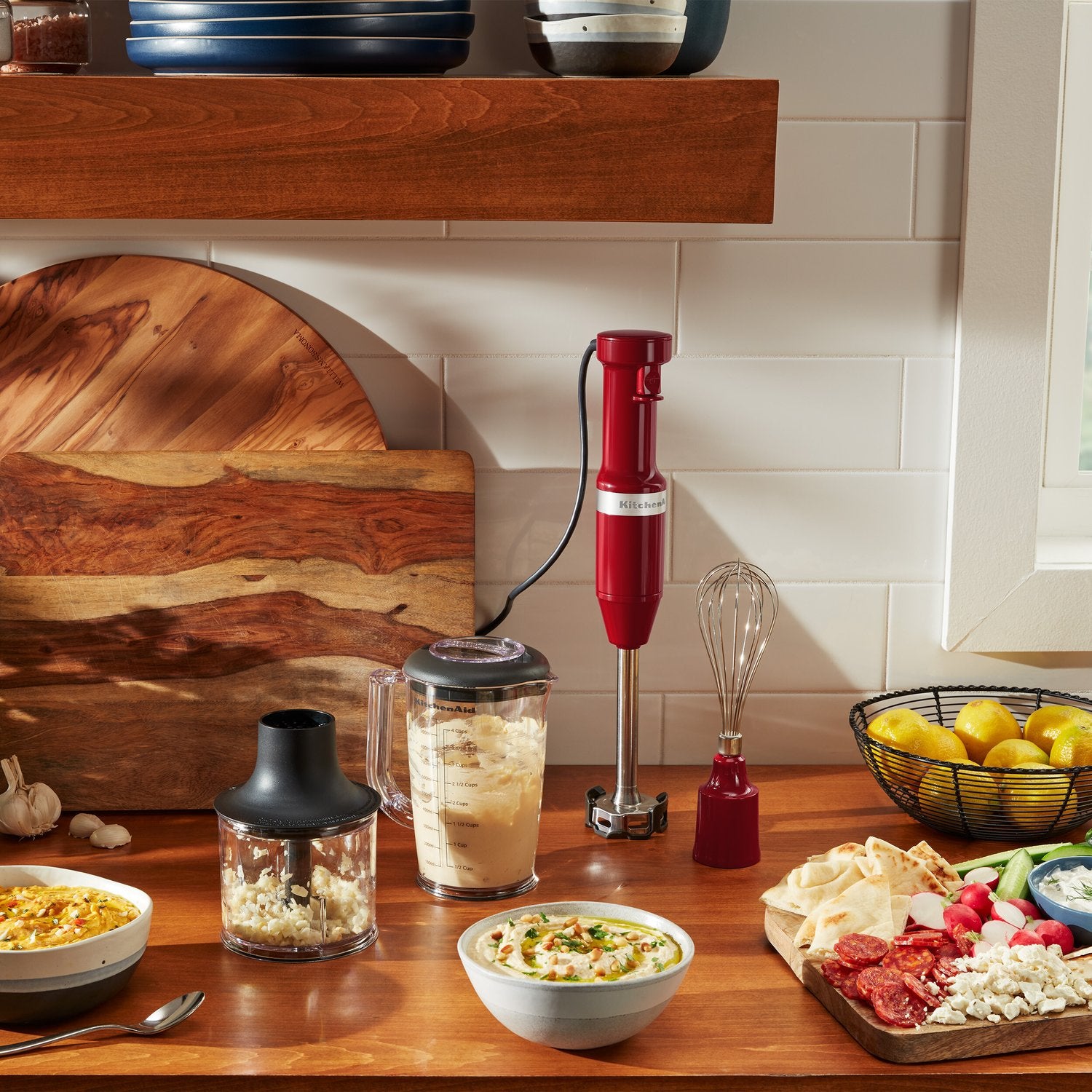 Corded immersion blender set with red blending jar, lid, and whisk attachment