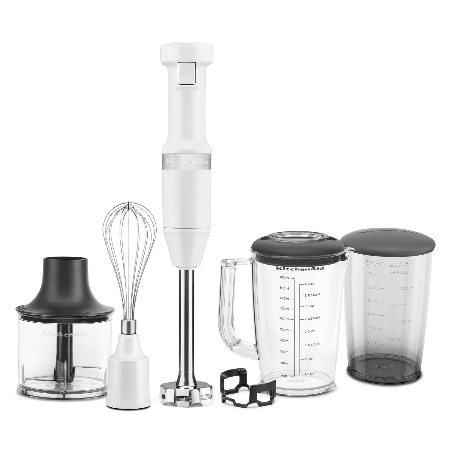 White immersion blender with blending shaft, whisk attachment, and measuring jar set