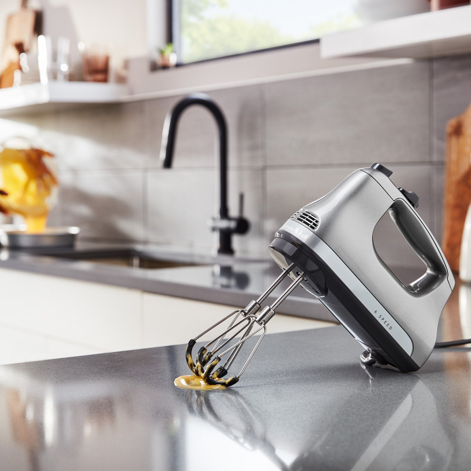 Flex Edge beater accessory silver wire beaters on a grey hand mixer