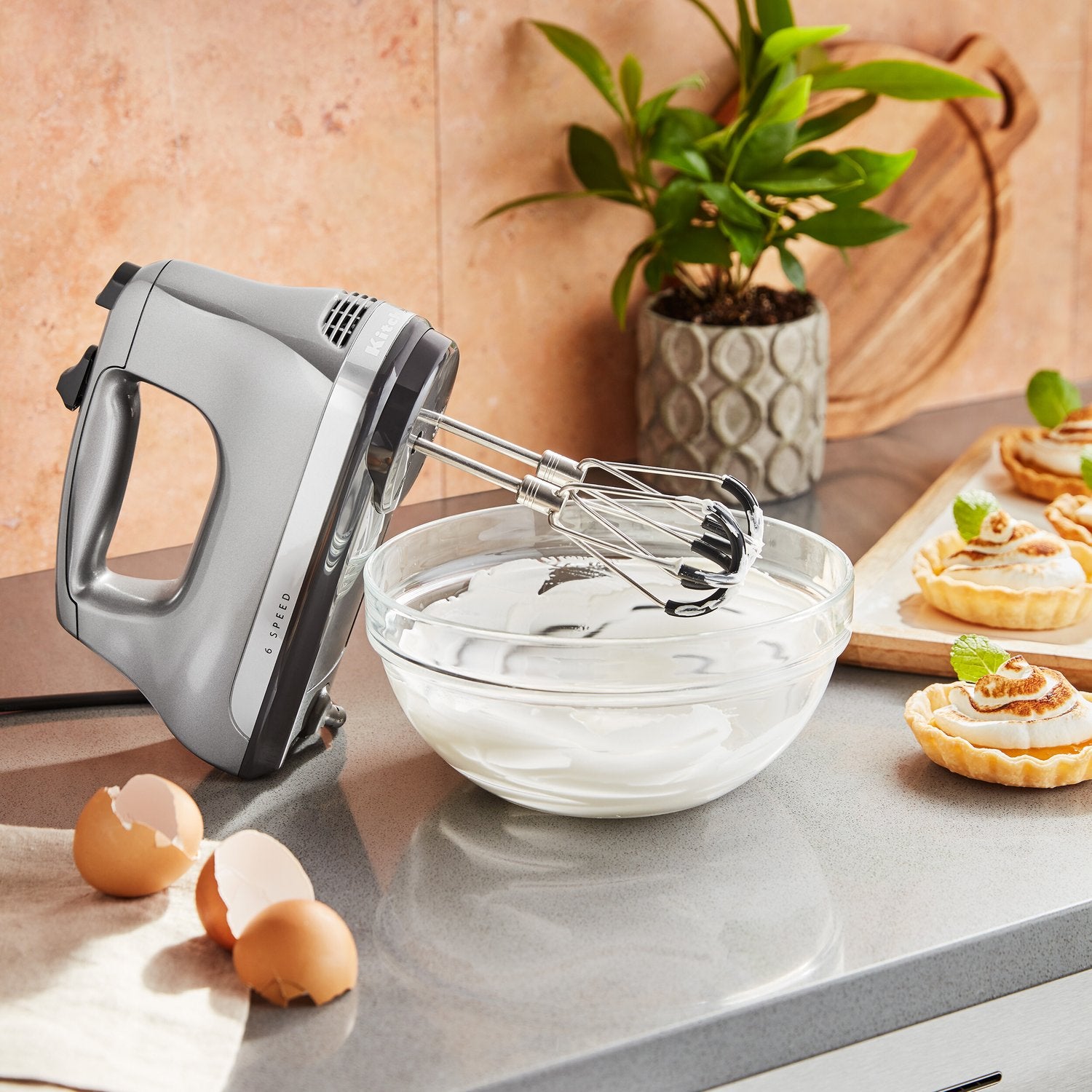 Flex Edge beater accessory with silver wire beaters on a grey hand mixer