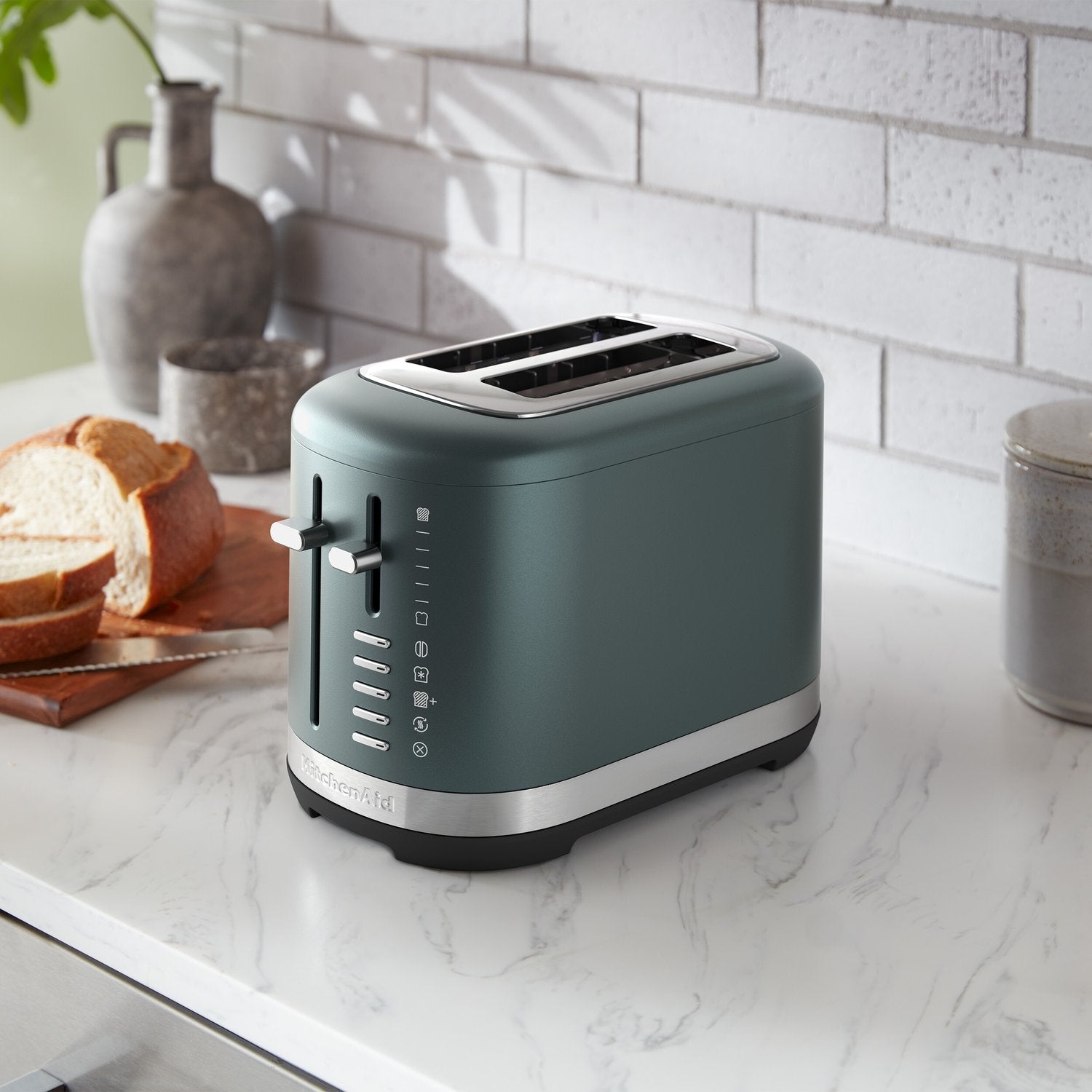 KitchenAid 2-slice toaster in juniper, angled view of top slots and side control panel
