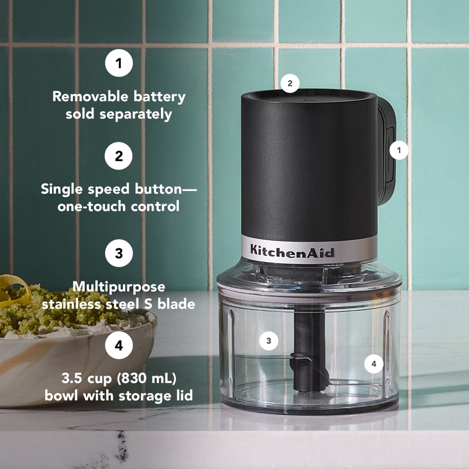 Black cordless chopper on clear 3.5-cup bowl with storage lid