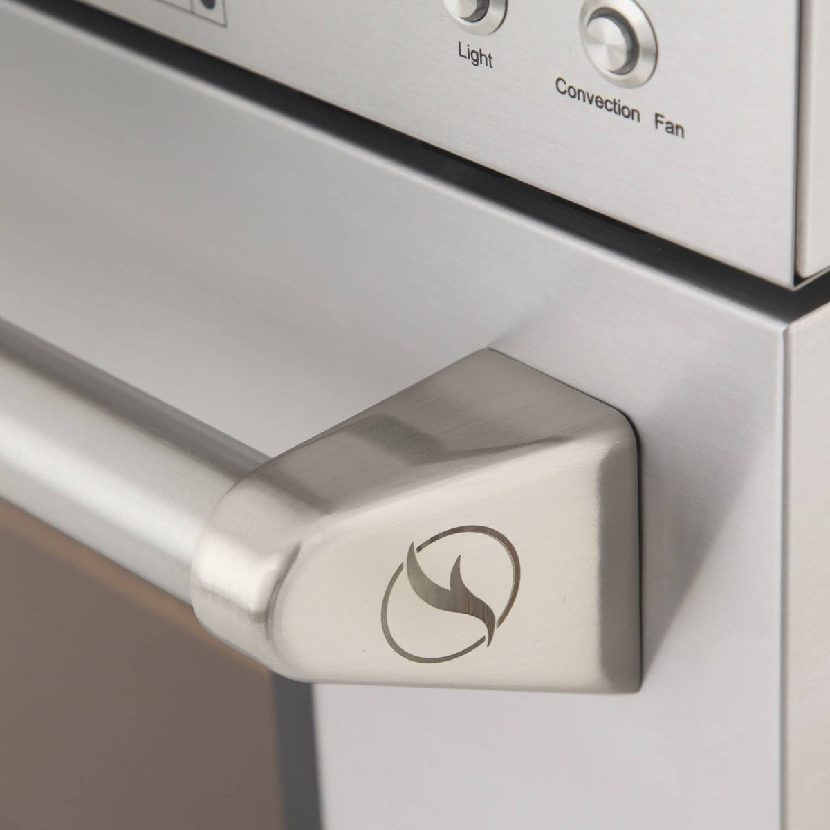Oven gas control knob with flame icon on a stainless steel panel