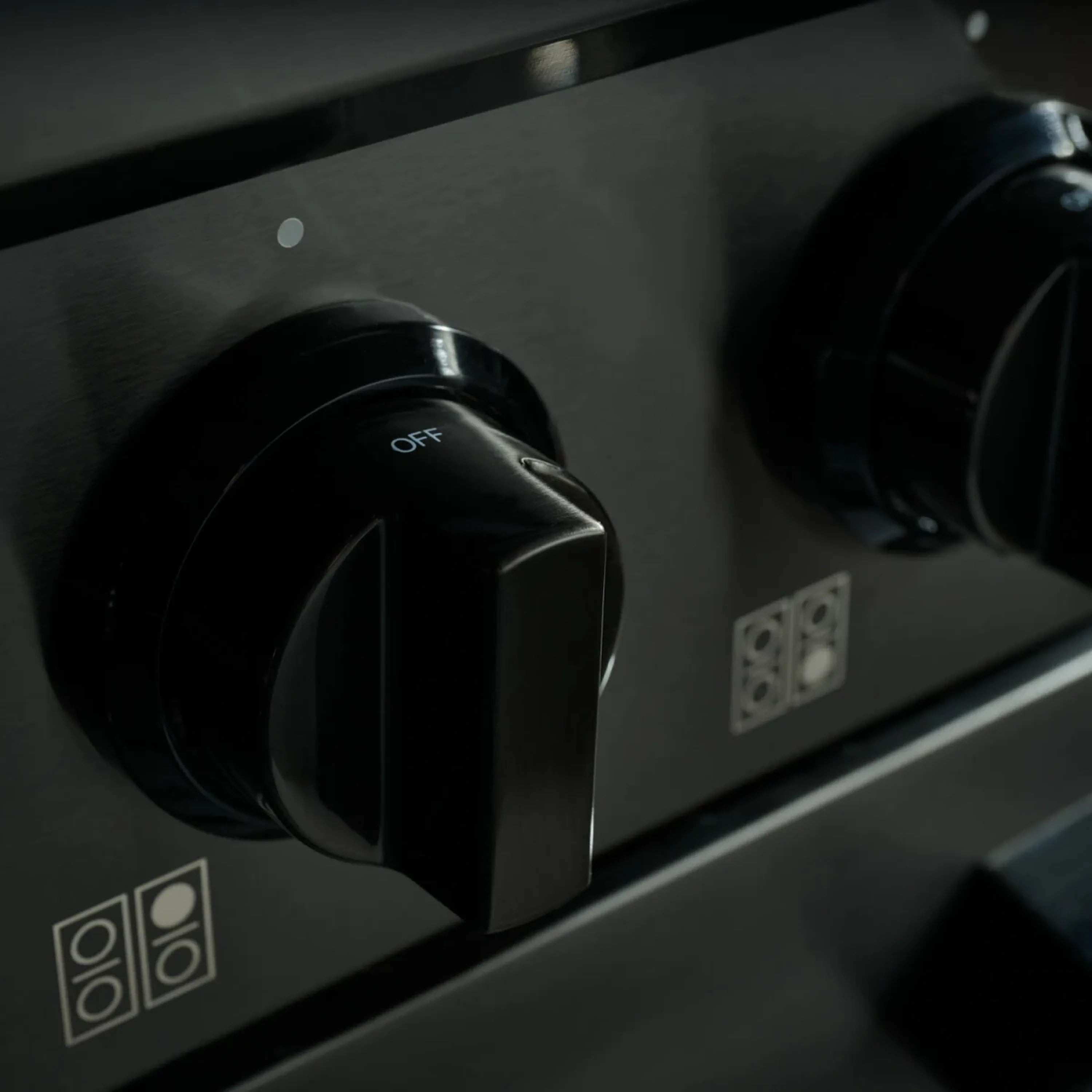 Gas dual-fuel range control knob labeled OFF with black rotary dial