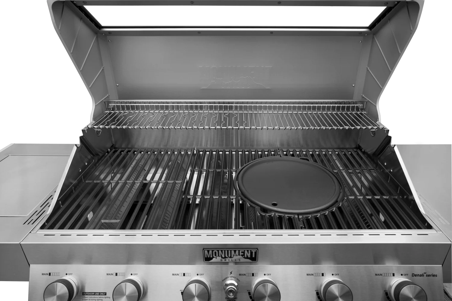 Round cast iron cooking plate in an open grill with ridged surface and outer rim