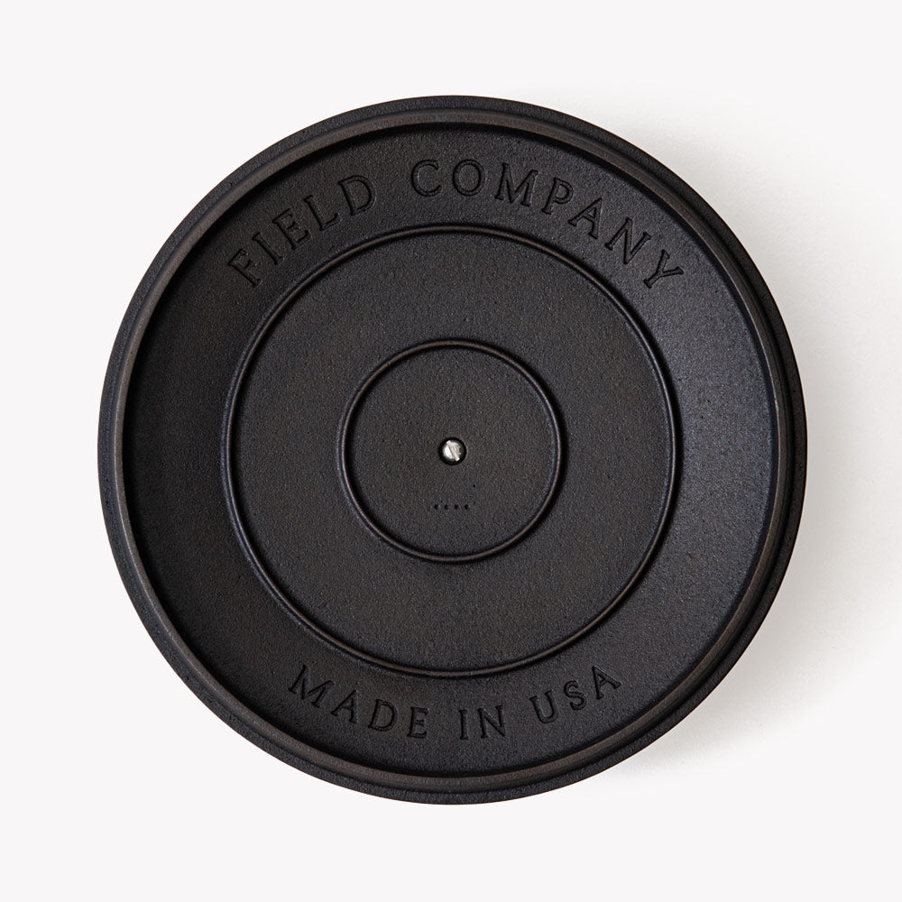Cast-iron skillet lid underside with Field Company logo and 'Made in USA'
