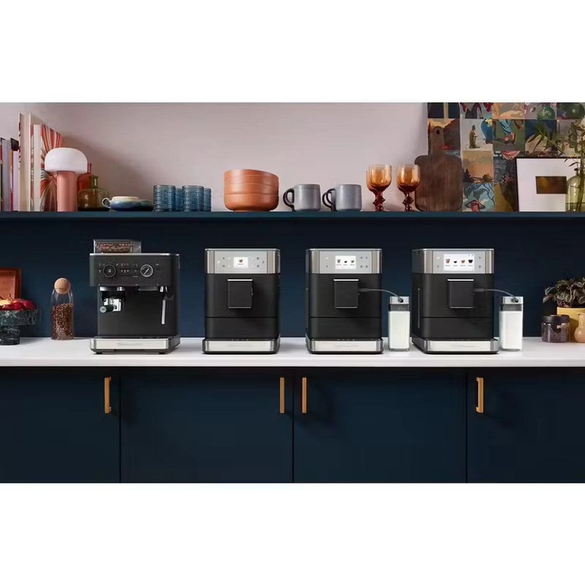 Multiple black and stainless fully automatic espresso machines lined up on a kitchen shelf.