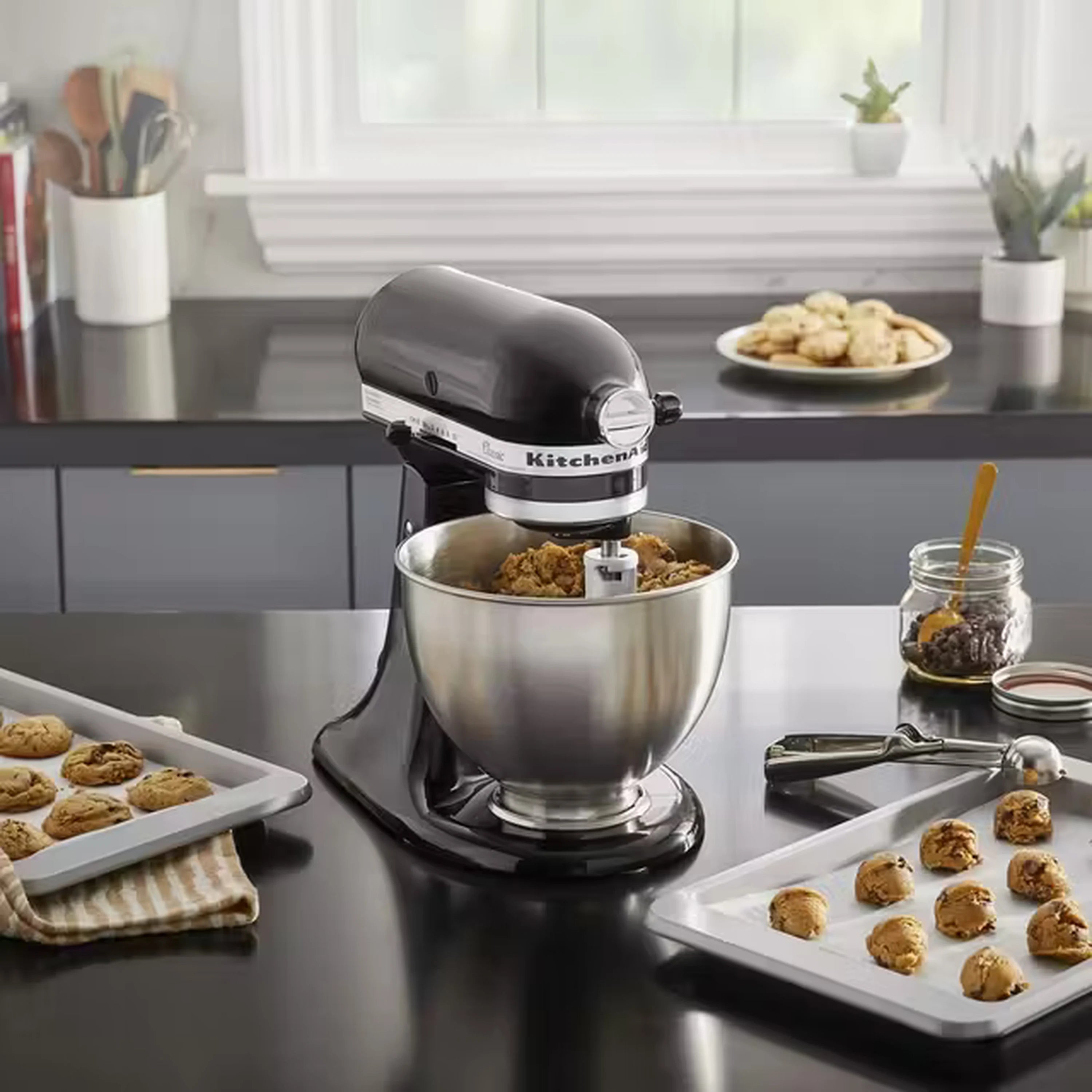 Onyx black stand mixer with stainless bowl baking tray cookies nearby