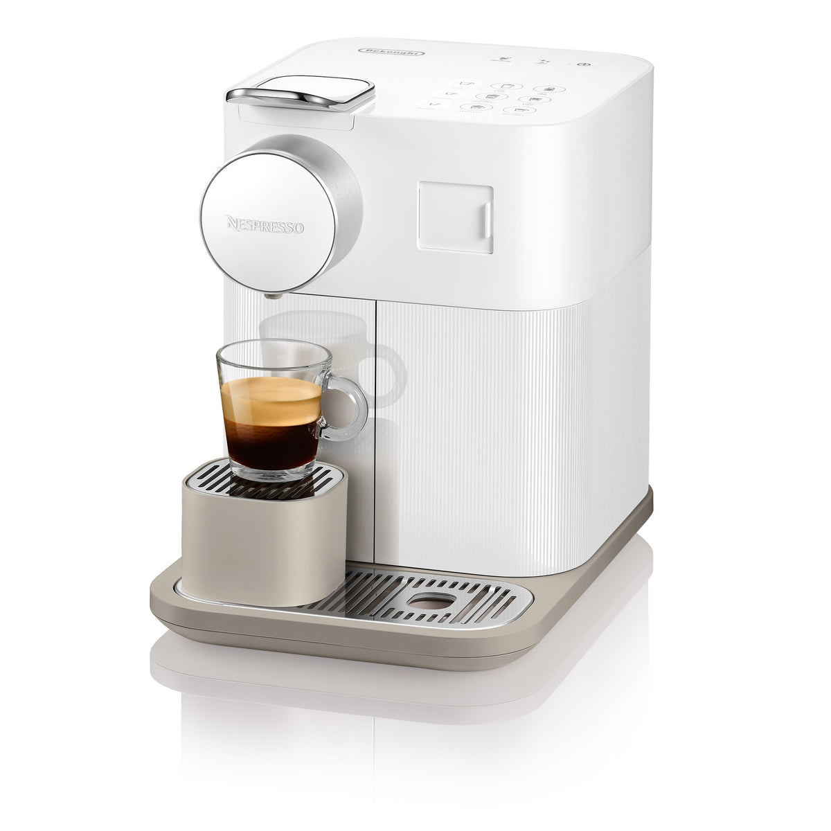 White Nespresso coffee machine with cup on platform and front frother dial