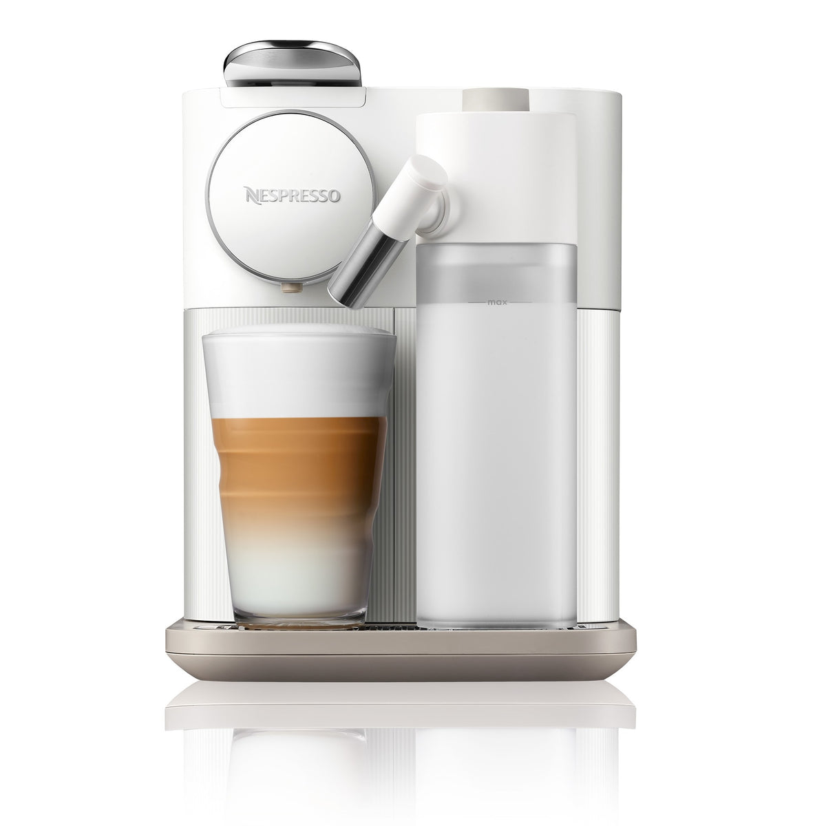 White Nespresso coffee machine front view with cup under spout and milk container