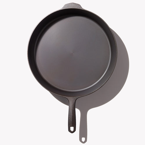 Black cast iron skillet interior with short loop handle