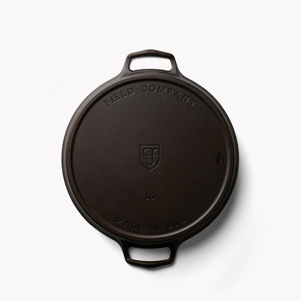 Cast iron skillet bottom view with Field Company logo and size marking 16