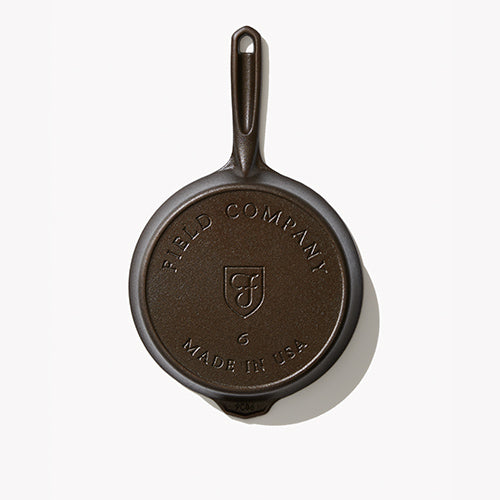 Cast iron skillet underside, textured base with shield and No.6 marking