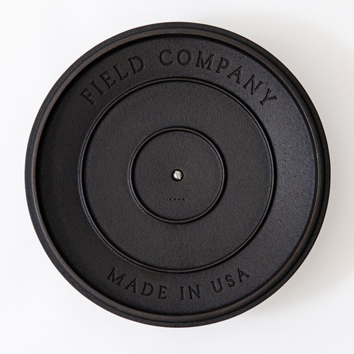 Black cast iron lid with Field Company and Made in USA text, top view