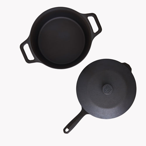 Two black cast iron pots: one with side handles, one with lid knob and loop handle