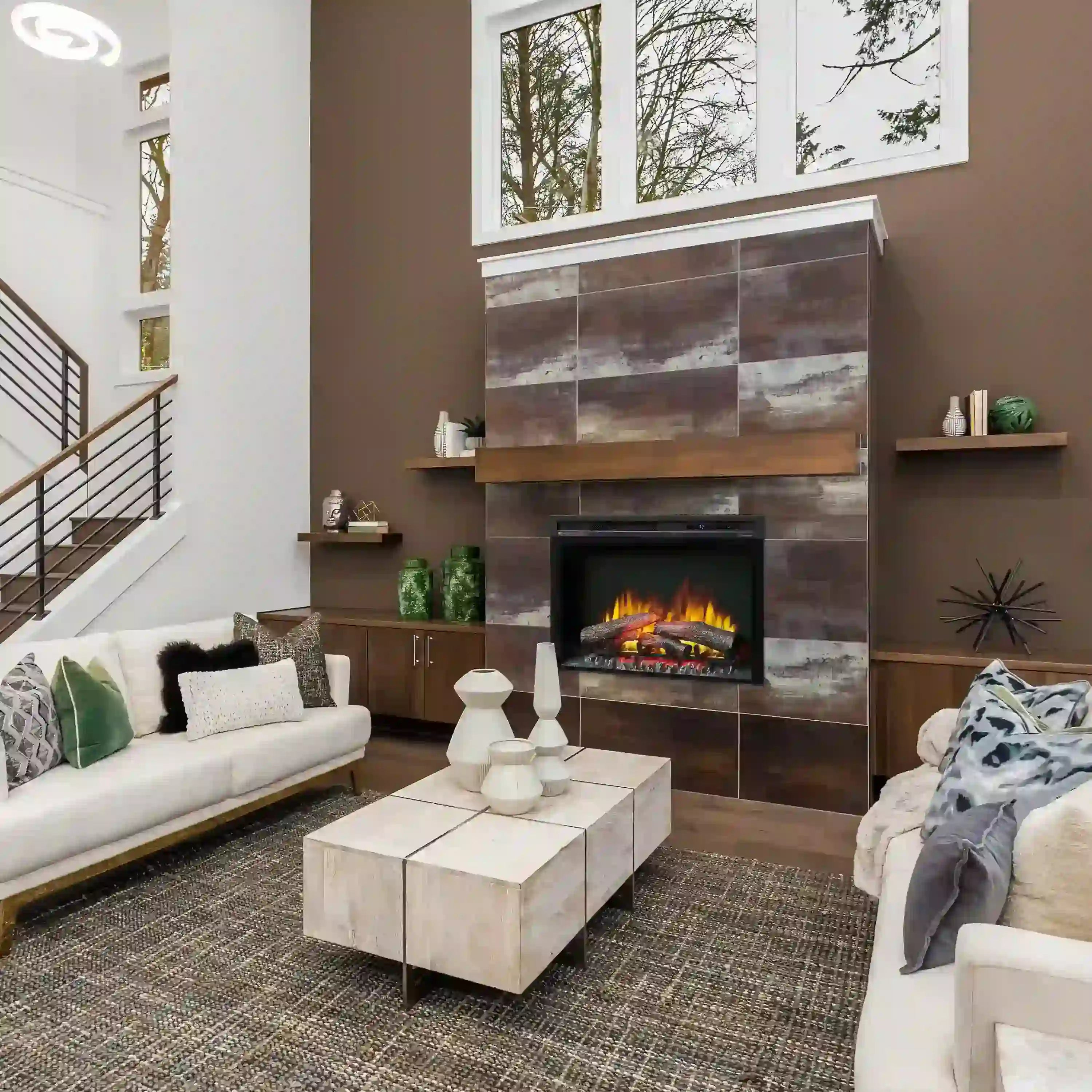 Electric fireplace insert in a wall opening with log flames visible through glass