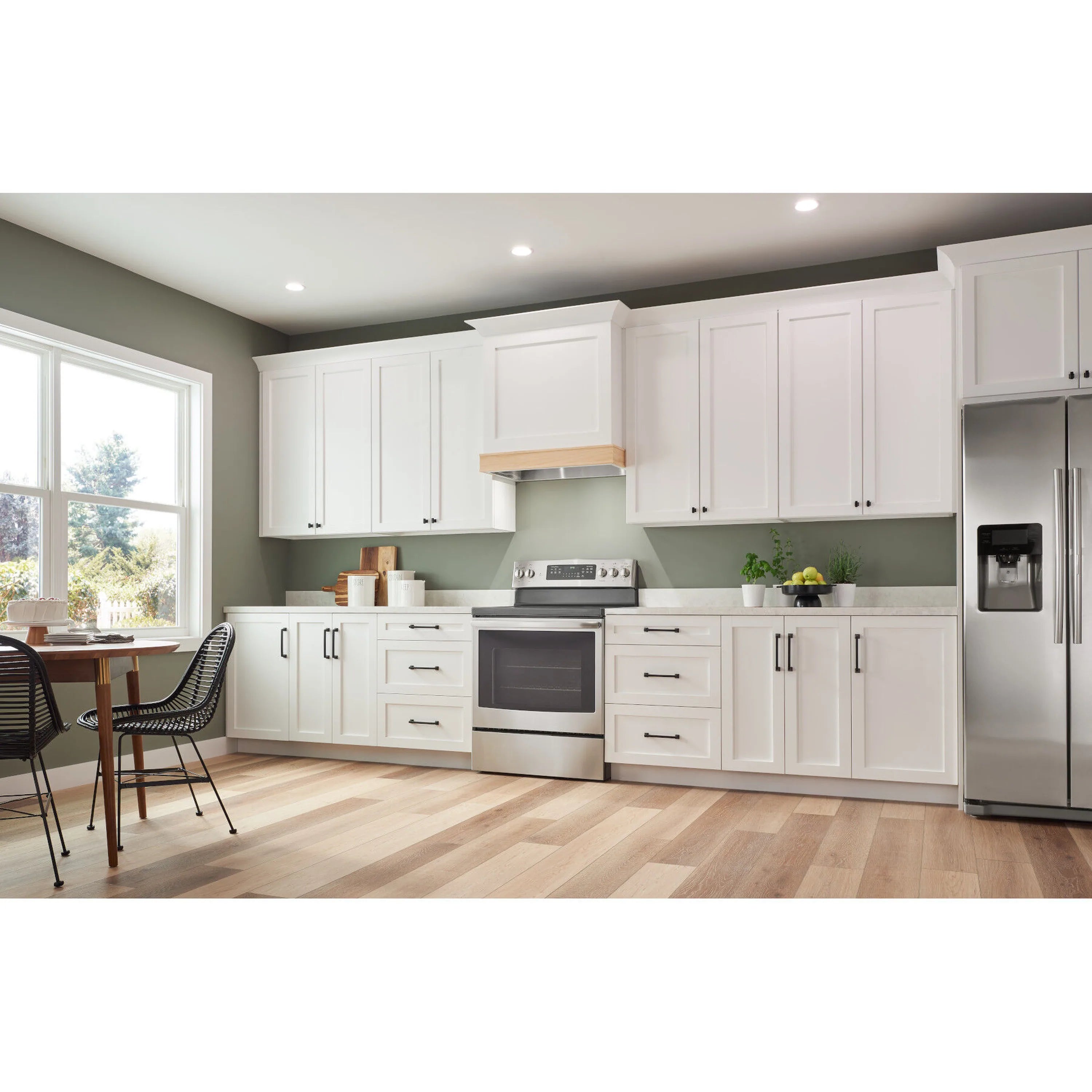 Stainless steel range hood mounted under kitchen cabinet with vent panel