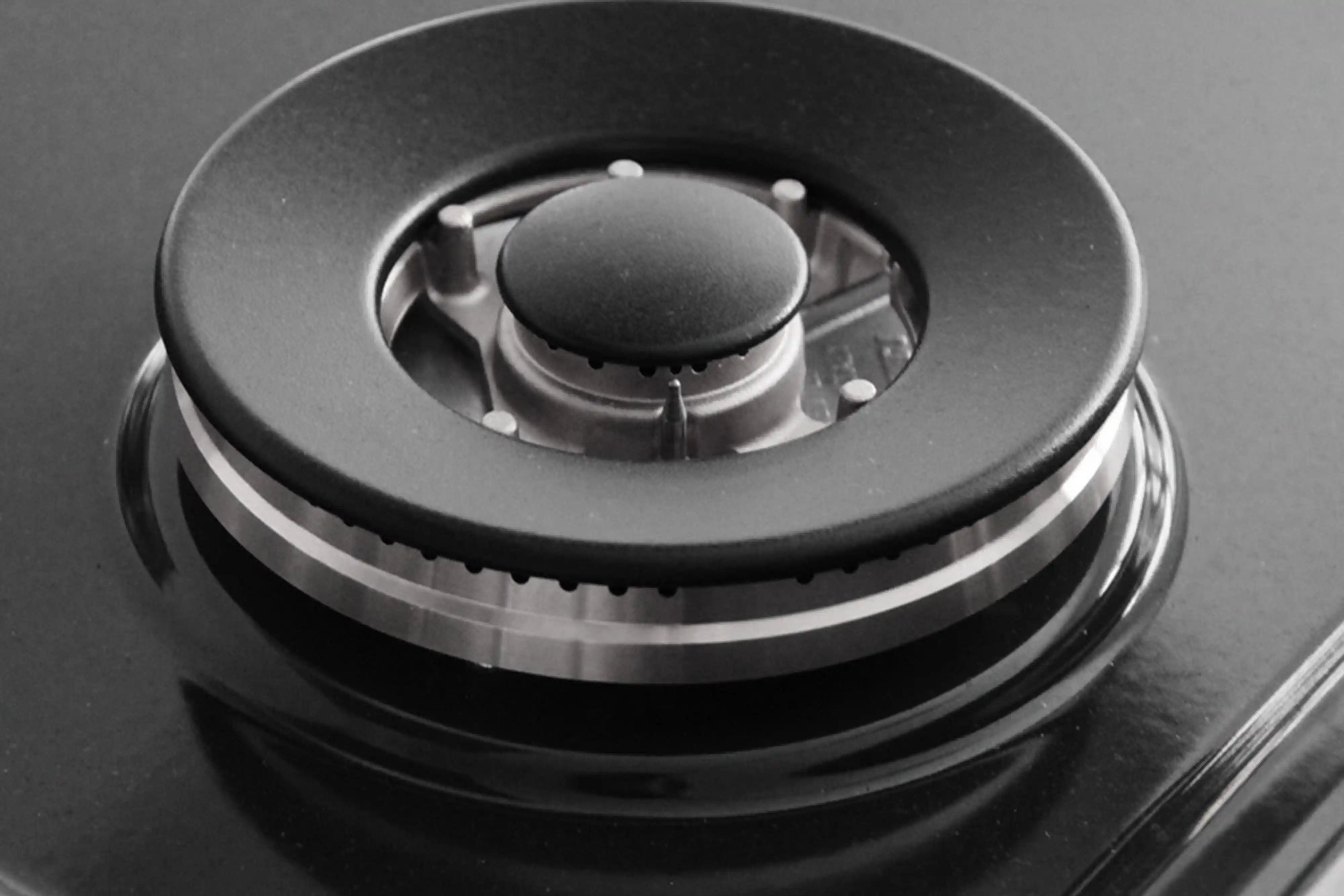 Black gas burner cap with metal flame ring and control knob base