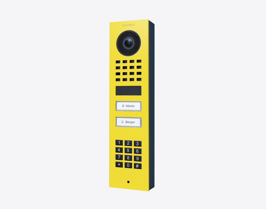 DoorBird surface-mount video door station with camera and keypad, sulfur yellow panel