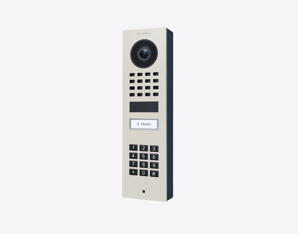 DoorBird surface-mount IP video door station in grey with camera lens, keypad, call button