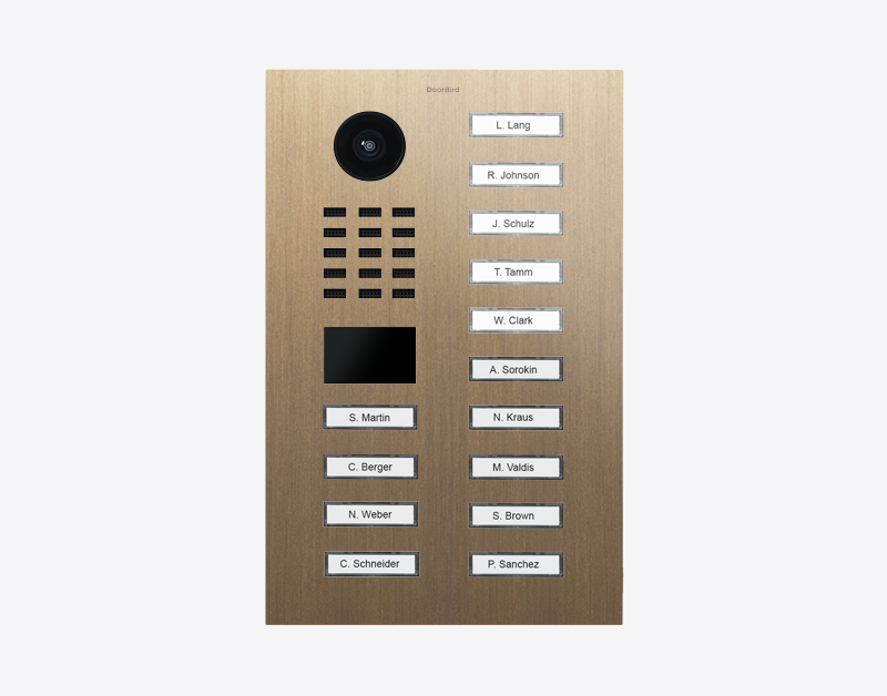 DoorBird video door station in burnished brass with camera lens and labeled call buttons