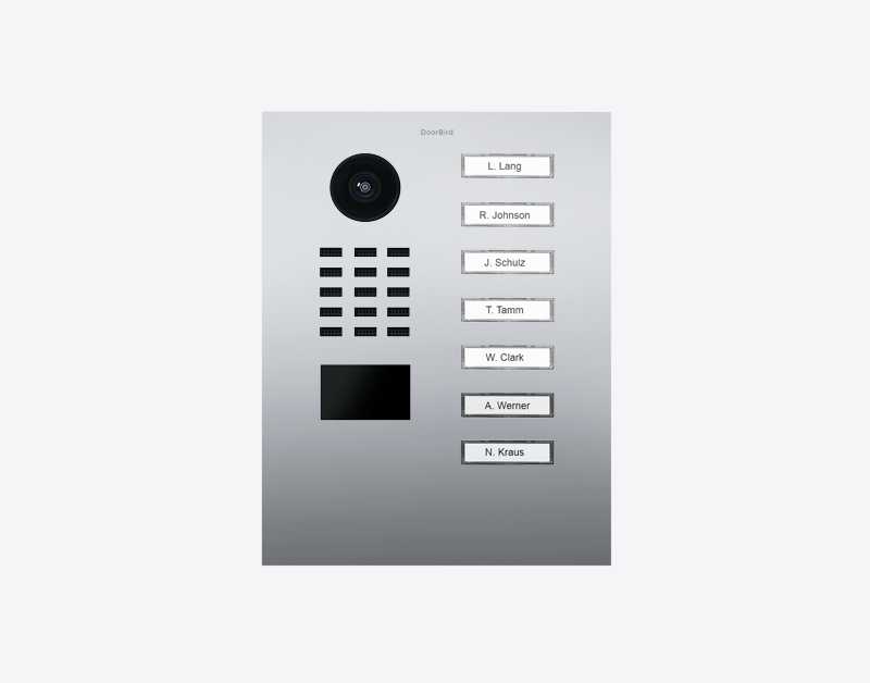 Video door station with circular camera, speaker grille, and seven call button name plates