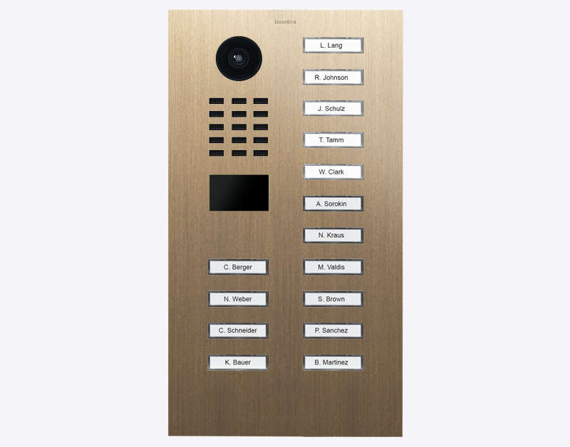 DoorBird video door station in burnished brass with camera lens and 15 name call buttons