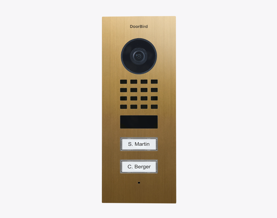DoorBird flush-mount IP video door station, gold finish with camera and keypad.