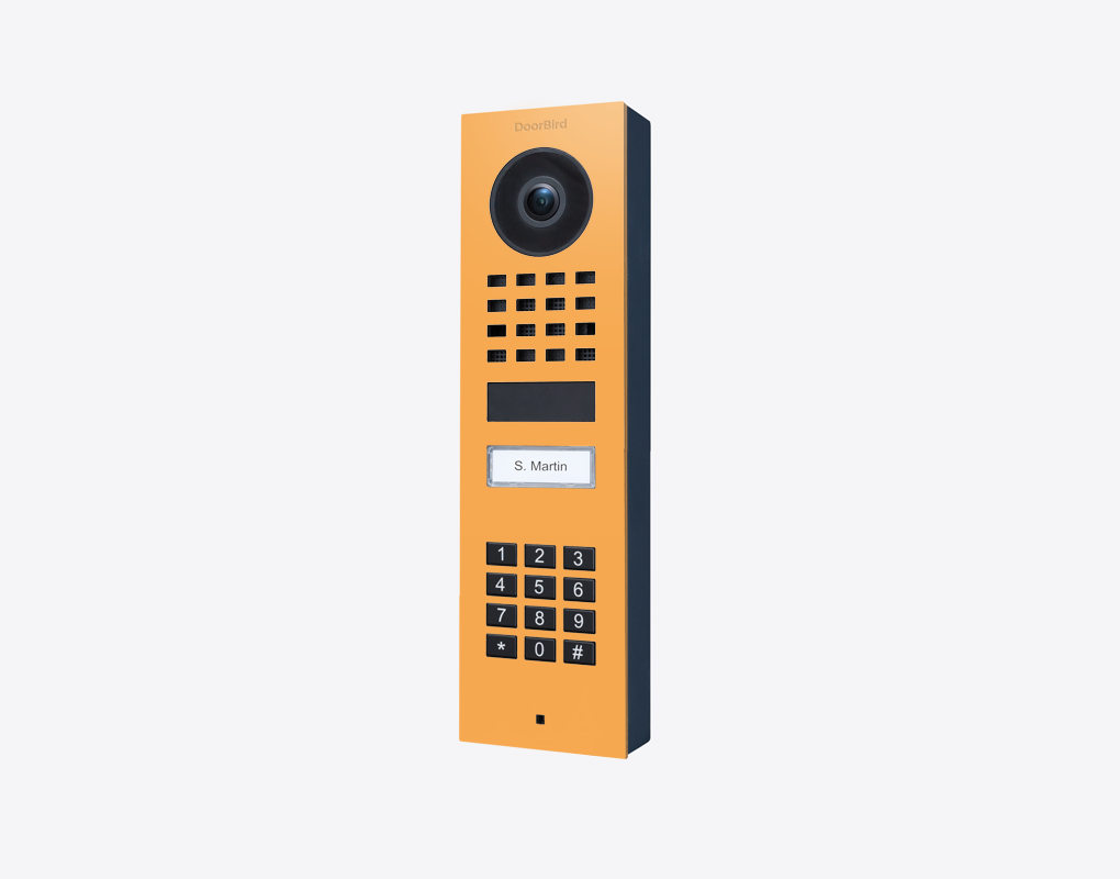 DoorBird surface-mount IP video door station, saffron yellow face, camera and keypad