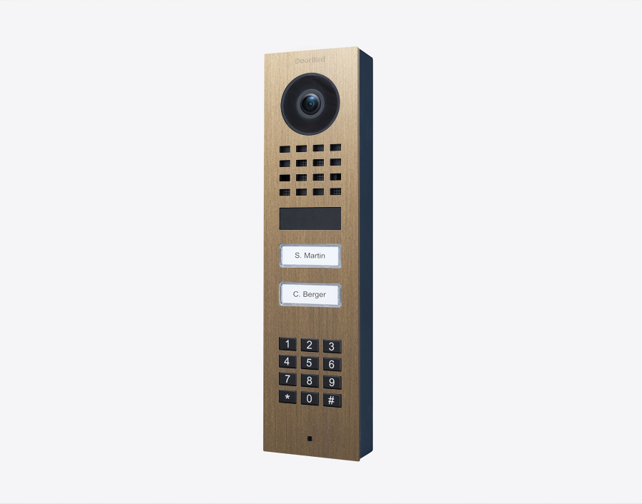 DoorBird brass video door station with camera lens, keypad, and two name call buttons