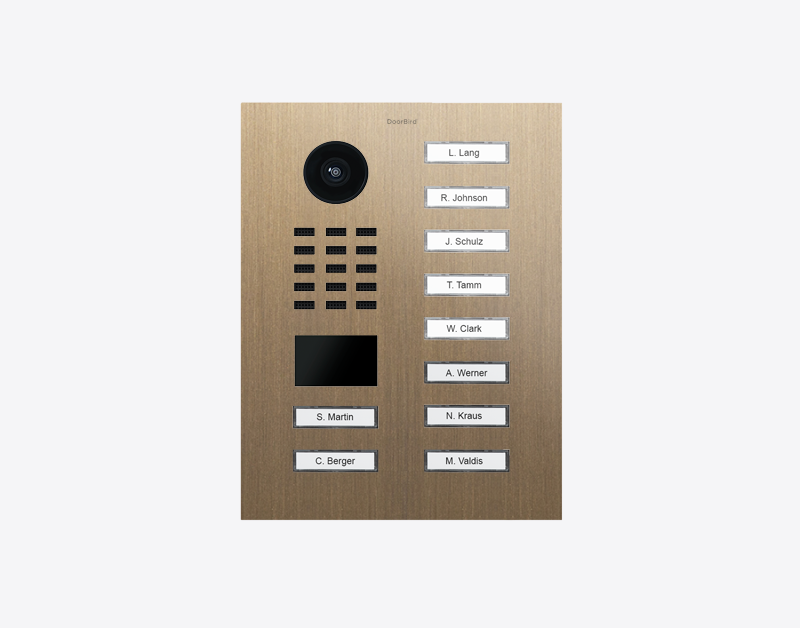 DoorBird IP video door station in burnished brass with black camera lens and 10 name call buttons